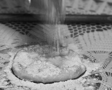 Making the Greek phyllo dough -Choriatiko- with a dowel rod