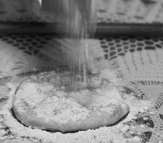 Making the Greek phyllo dough -Choriatiko- with a dowel rod